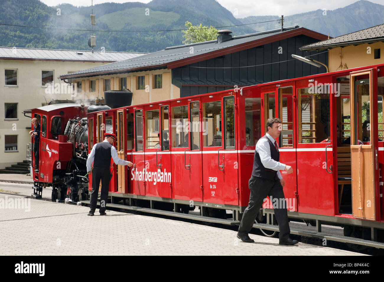 Red steam train on rack and pinion railway station platform to Schafberg mountain. St Wolfgang, Salzkammergut, Austria Stock Photo