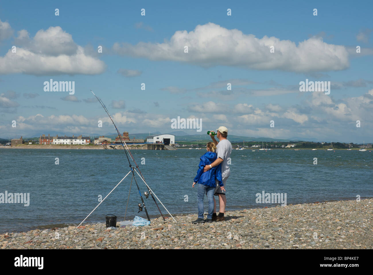 Man and woman seafishing on Piel Island, looking towards Roa Island