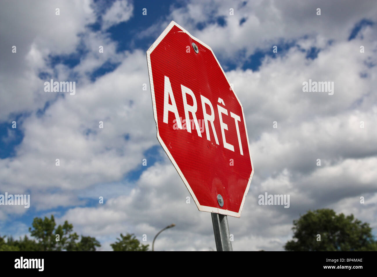 arret stop sign blue sky white cloud Stock Photo