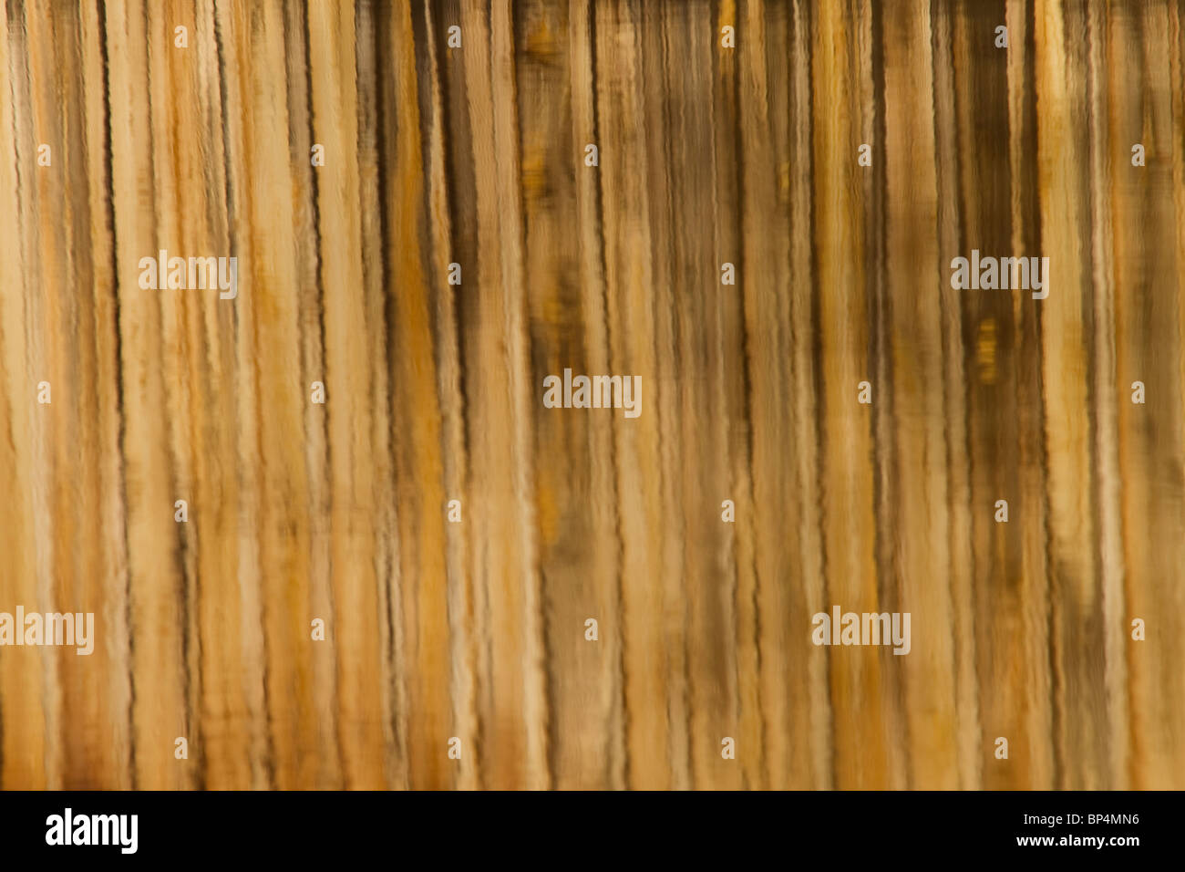 Shown here is a reflection of wooden bridge in water.  Brown Line Pattern Reflection of Wooden Bridge On Water Stock Photo