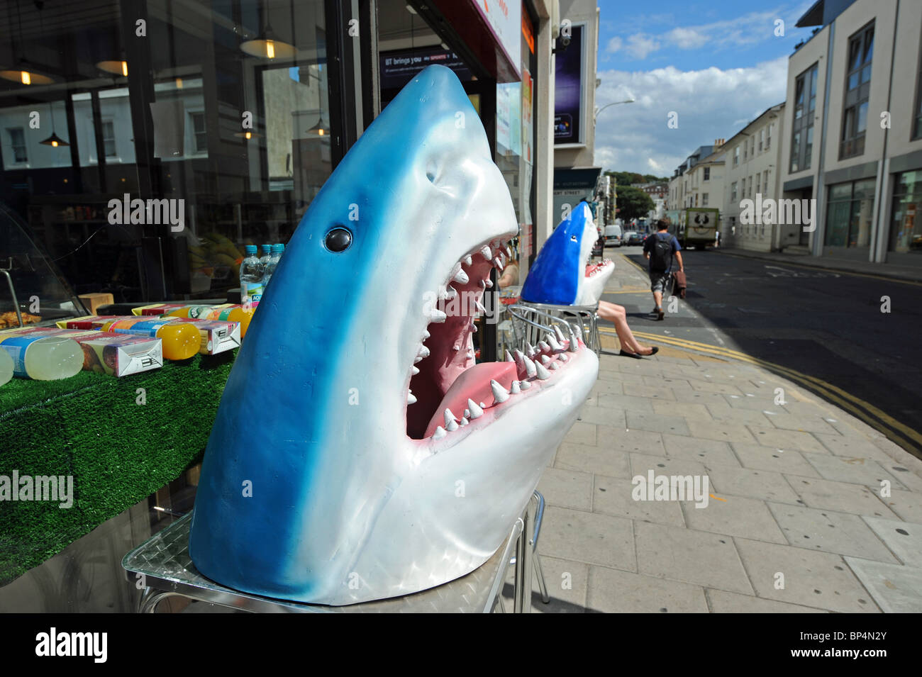 Large plastic shark head sculptures outside a shop in North Road Brighton UK Stock Photo