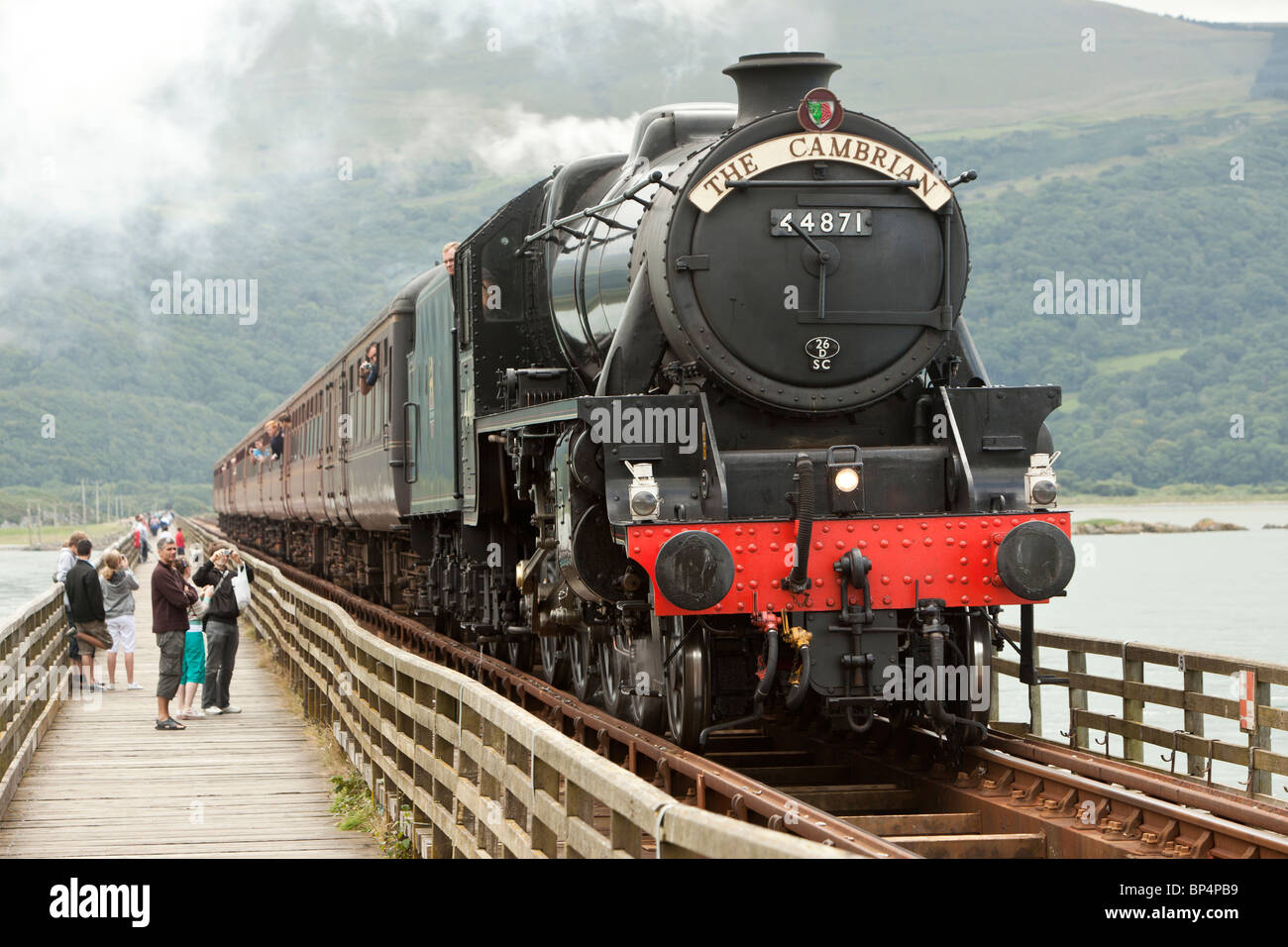 LMS 4-6-0 Black 5 locomotive number 44871 pulling 'The Cambrian', crossing the Barmouth Bridge, West Wales. Stock Photo