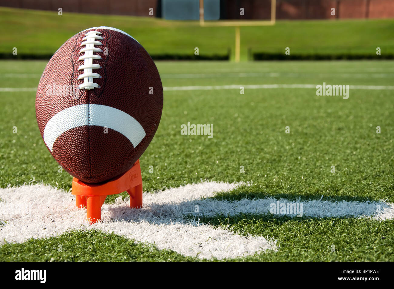 American Football on Kicking Tee on Field Stock Photo - Alamy