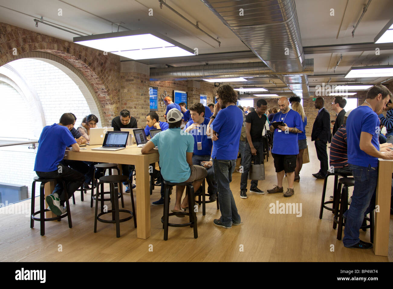 A Genius Bar Reservations Sign at an Apple Store in Front of the Genius Bar  Where Apple Employees are Helping Customers Editorial Stock Image - Image  of global, iphone: 237668444