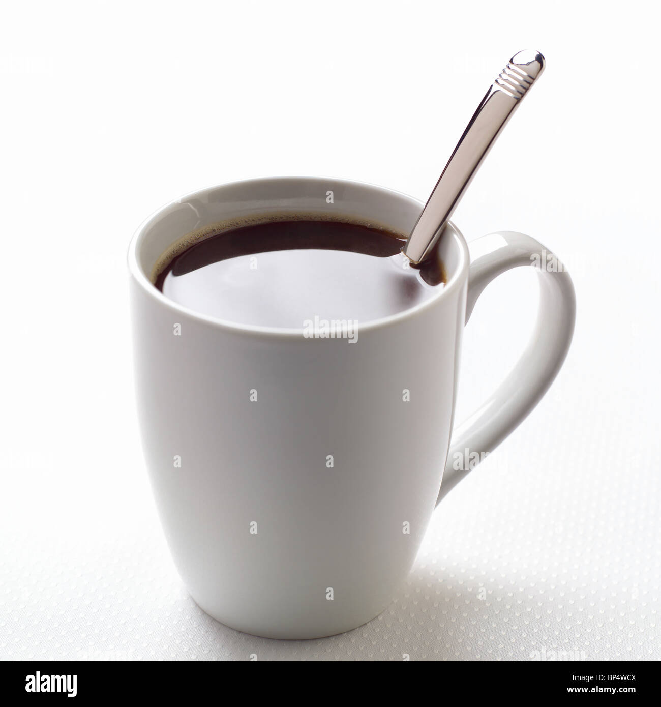 White mug of coffee with spoon Stock Photo