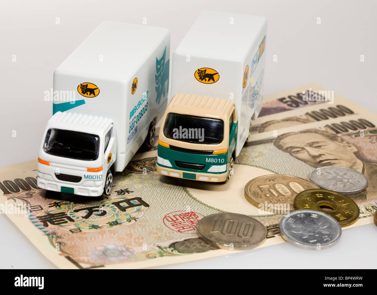 Toy trucks on Japanese yen Stock Photo