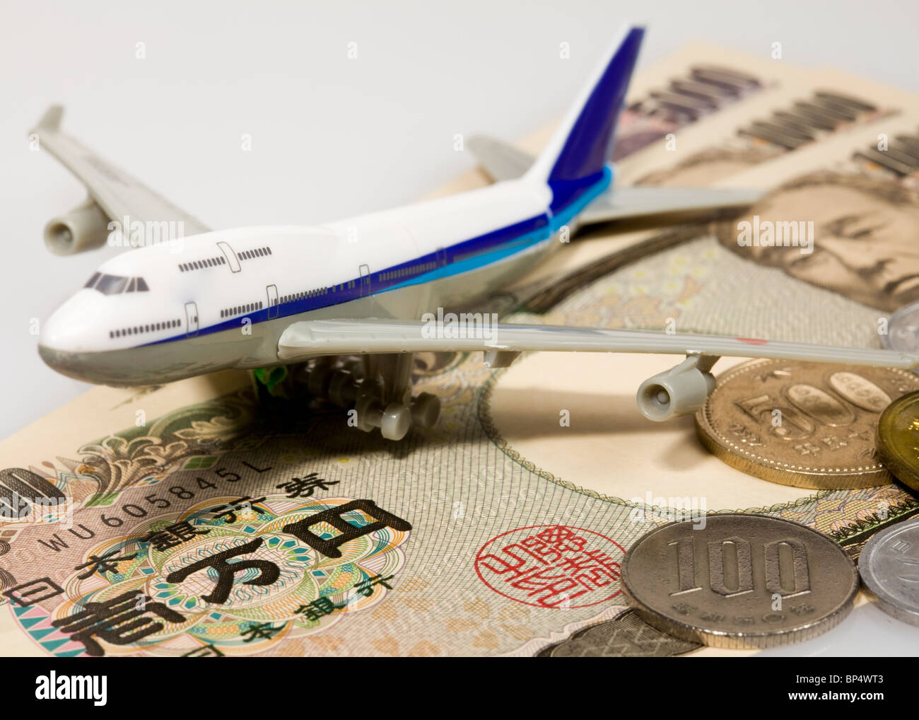 Toy airplane on Japanese yen Stock Photo