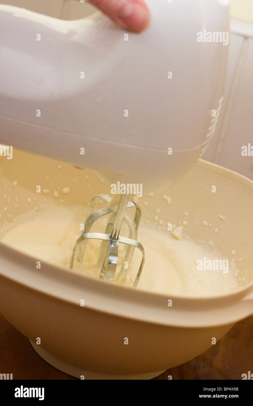 Electric beater mixing cream Stock Photo Alamy