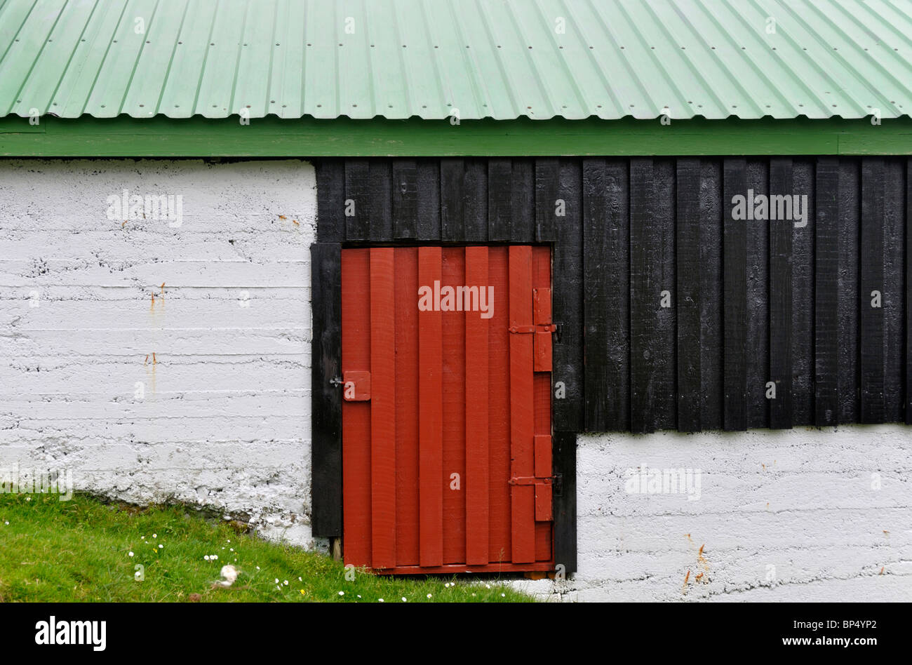 Red, white and green building, Norðtoftir, Borðoy, Faroe Islands Stock Photo