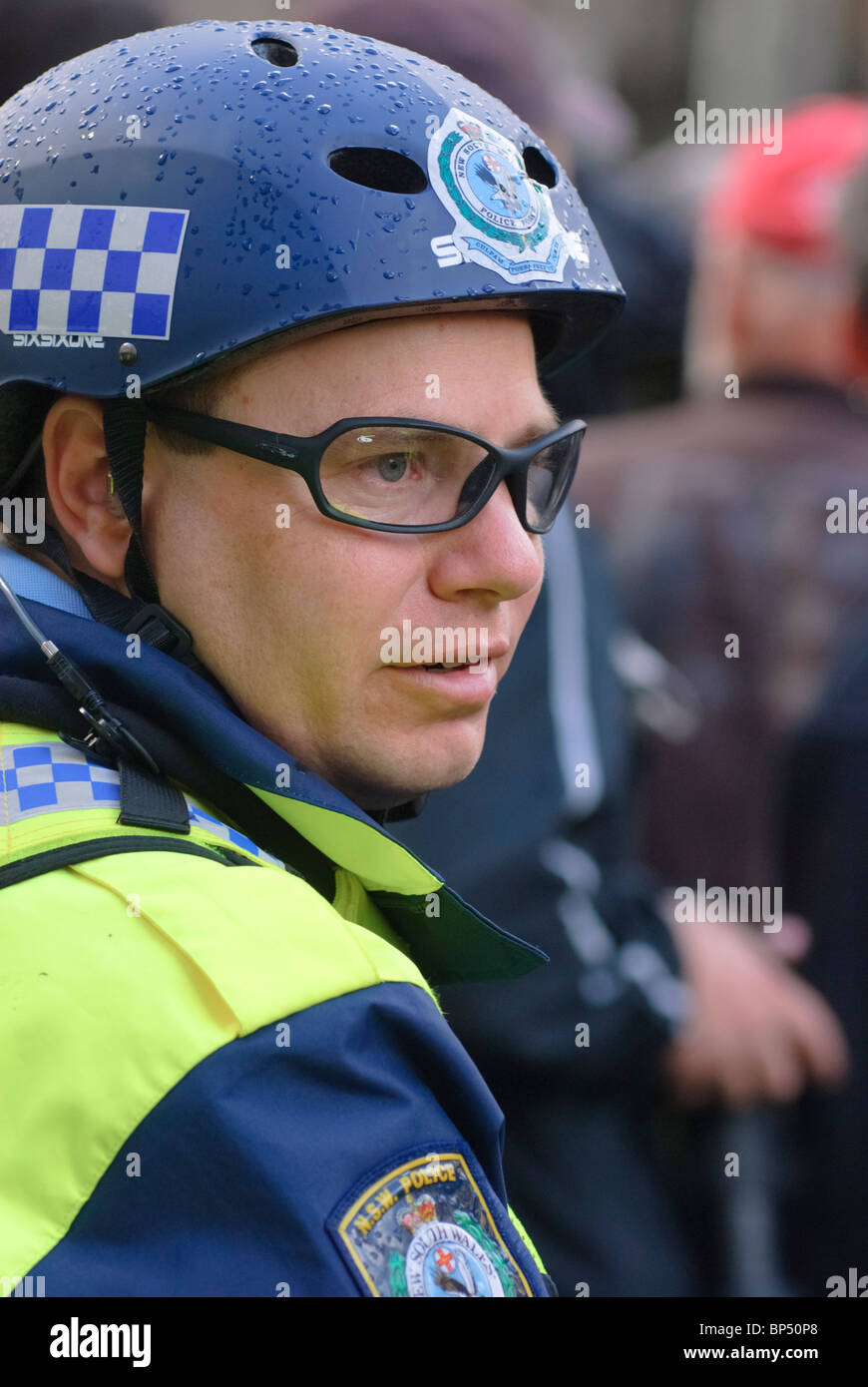 Bicycle policeman watches the crowds during a protest Stock Photo