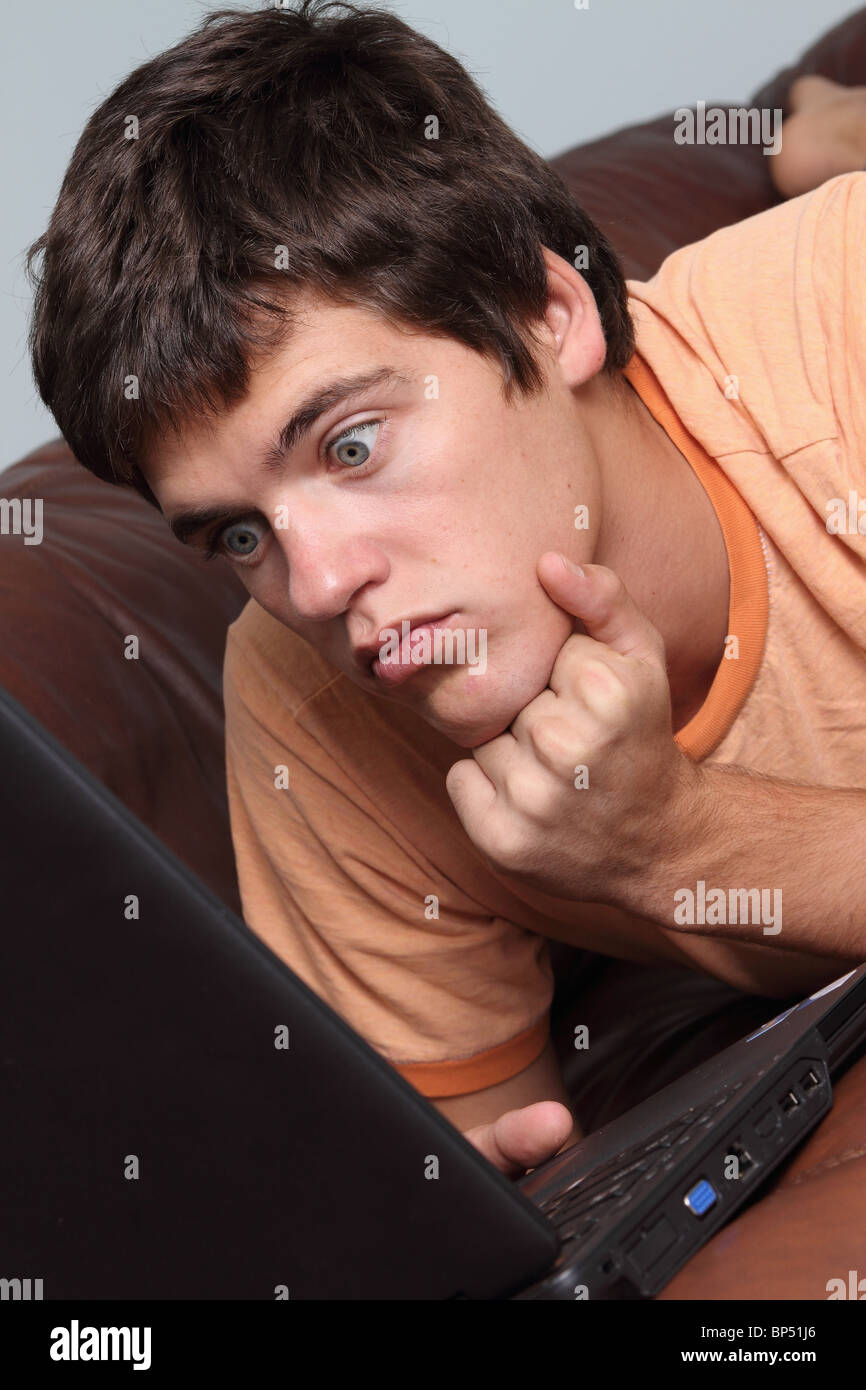 Surprised young man at the laptop computer Stock Photo