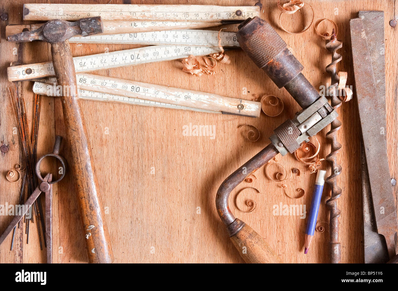still-life composition of grungy old hand tools on wood texture, empty space for text Stock Photo