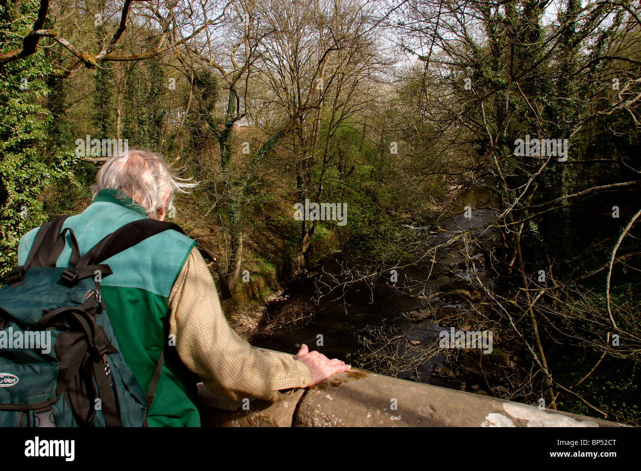 UK, England, Cheshire, Stockport, Marple, Roman Lakes, River Goyt, man on bridge looking at river Stock Photo