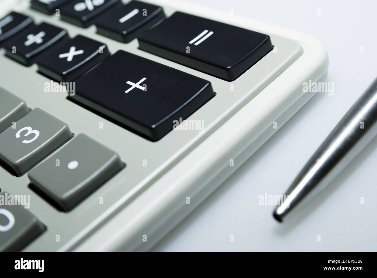 Calculator and pen on white background Stock Photo - Alamy