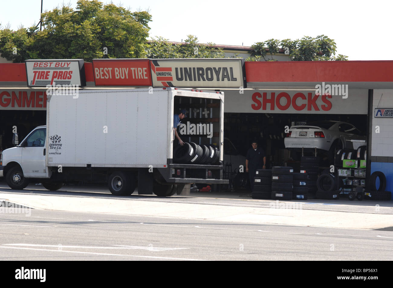 Tire sales and car repair taking delivery of a shipment of tires Stock