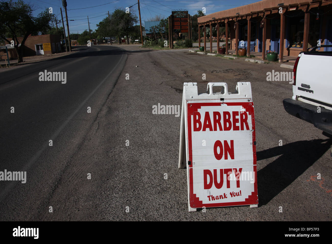 Barber on duty sign in parking lot of strip mall in Corrales, Sandoval County, New Mexico, June 10, 2010 Stock Photo