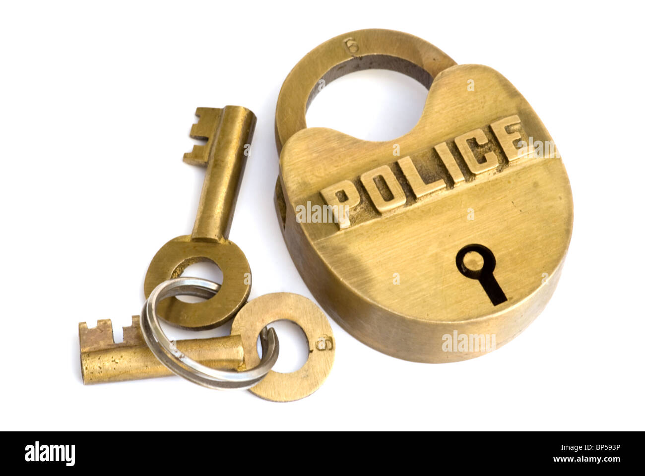 Brass police logo lock with key chain and two keys. The word police is in capital letters above the keyhole. Stock Photo