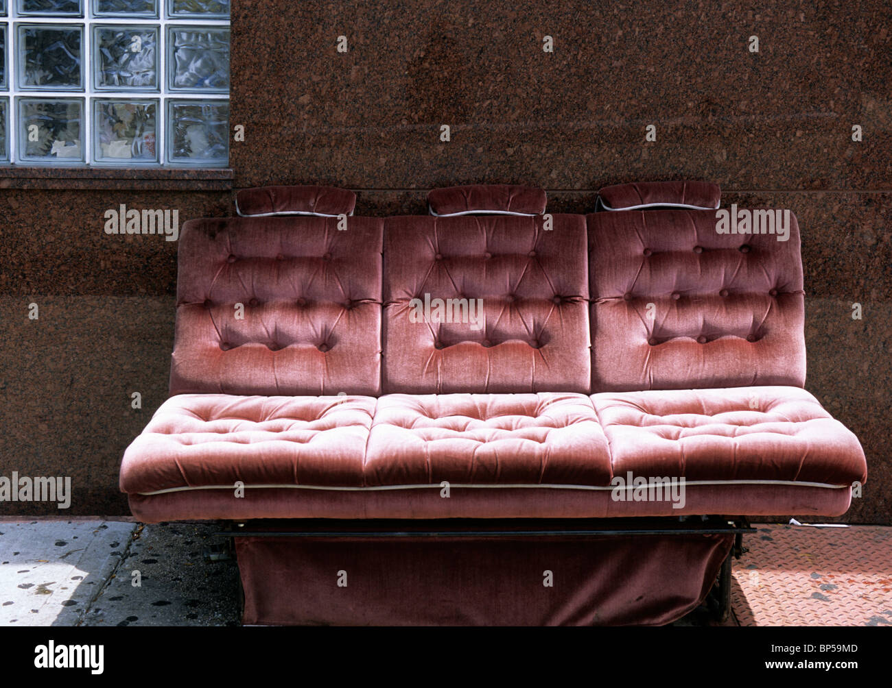 Art Deco sofa on the street In New York City. The Bronx. Discarded old