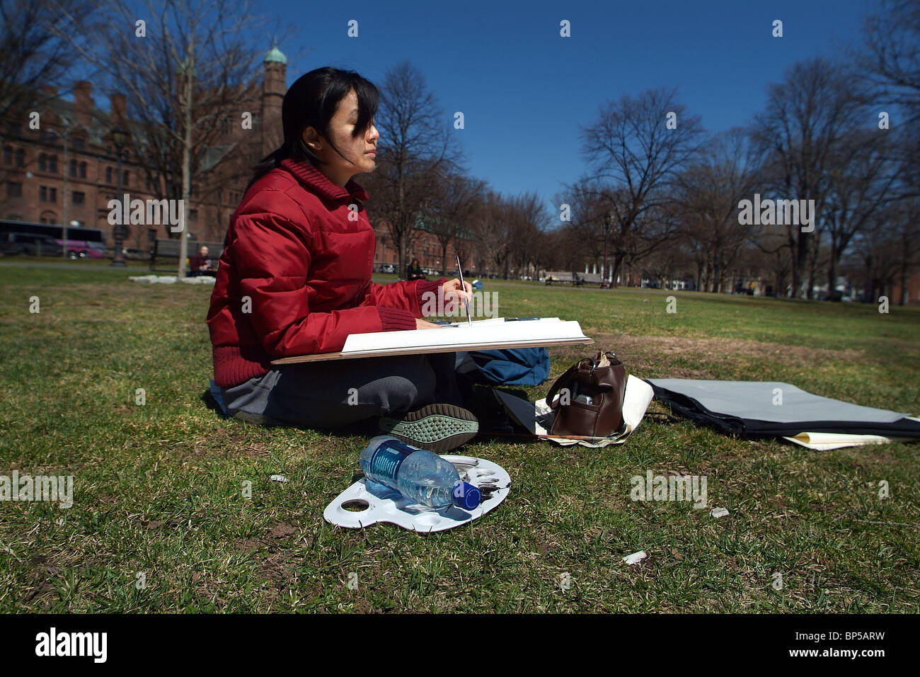 A Yale University Art student paints a landscape outside on the New Haven Green in the early spring. CT USA Stock Photo