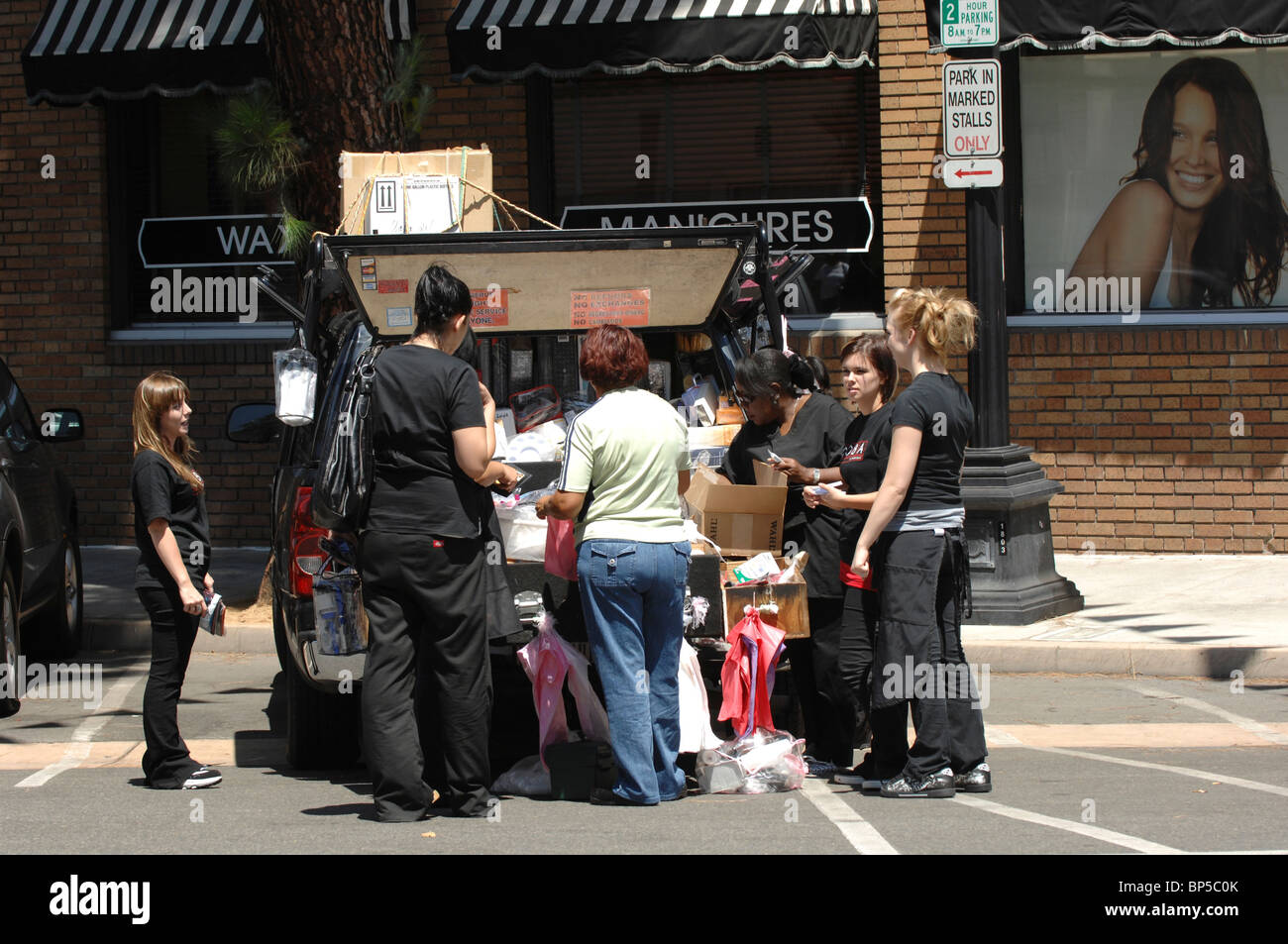A street vendor sells hair care, cosmetic, and salon products to a group of cosmetology students in Orange, California Stock Photo