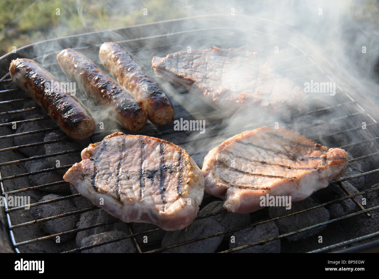 Grilled saussages and chops Stock Photo
