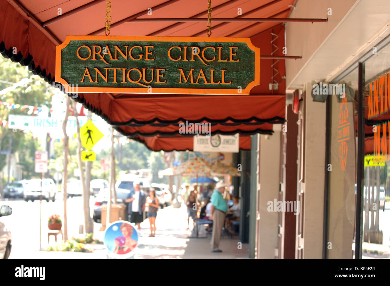 Orange Circle Antique Mall with several out-of-focus people in the background shopping on the sidewalk. Stock Photo