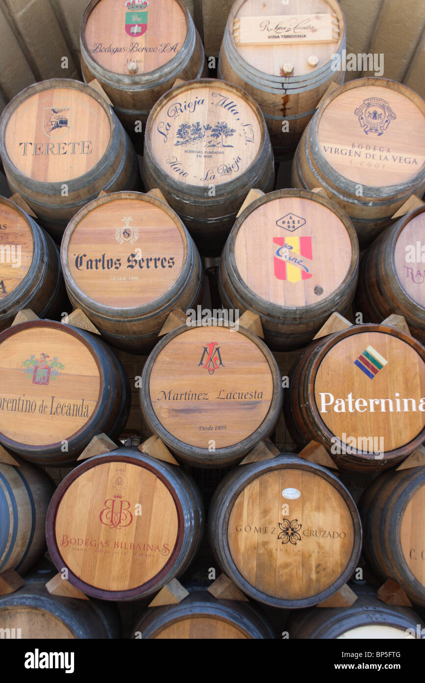 Stack of Wine Barrels with various producers names on ends, Haro, La Rioja, Spain Stock Photo