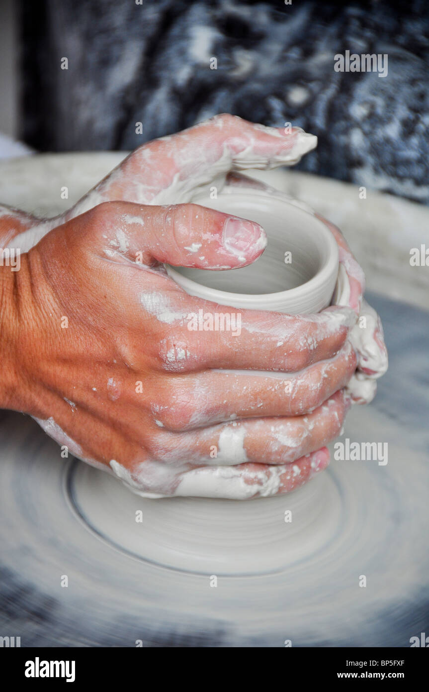 artist throwing clay pottery on a ceramics wheel Stock Photo Alamy