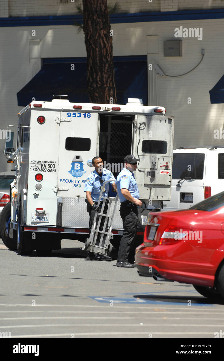 Armored car and currency delivery personnel enjoy their work while maintaining vigilance to maintain safety and security. Stock Photo