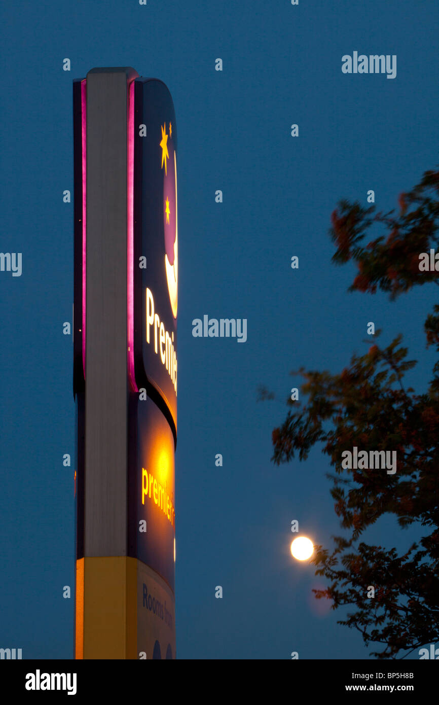 A Premier Inn sign and moon at night. Stock Photo