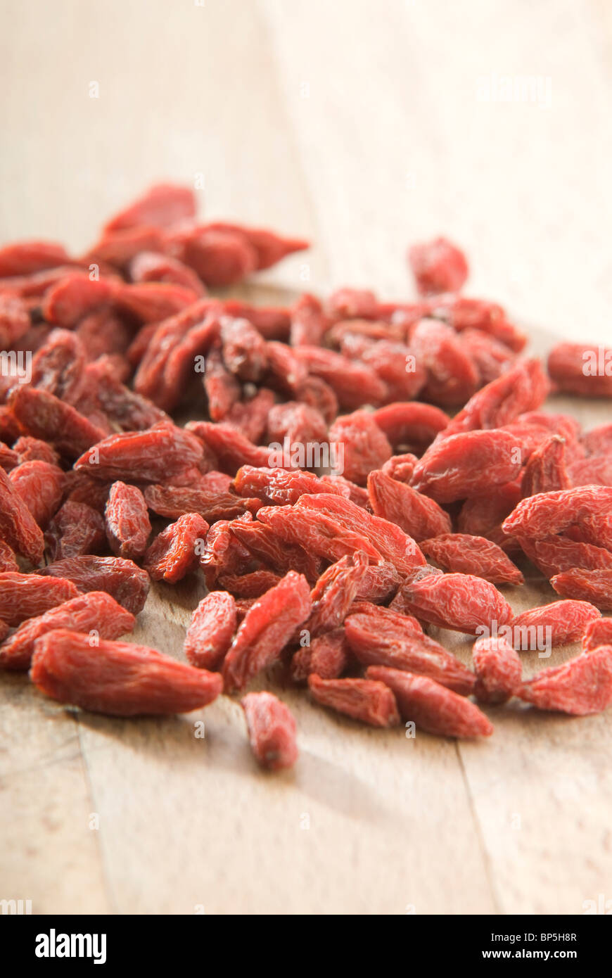 pile of red goji berries (Lycium chinense) on wooden board Stock Photo