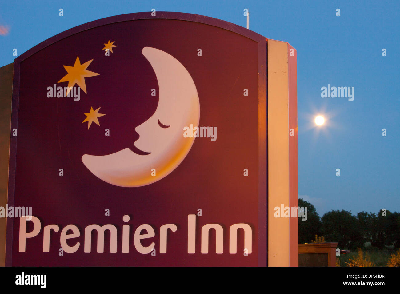 A Premier Inn sign and moon at night. Stock Photo