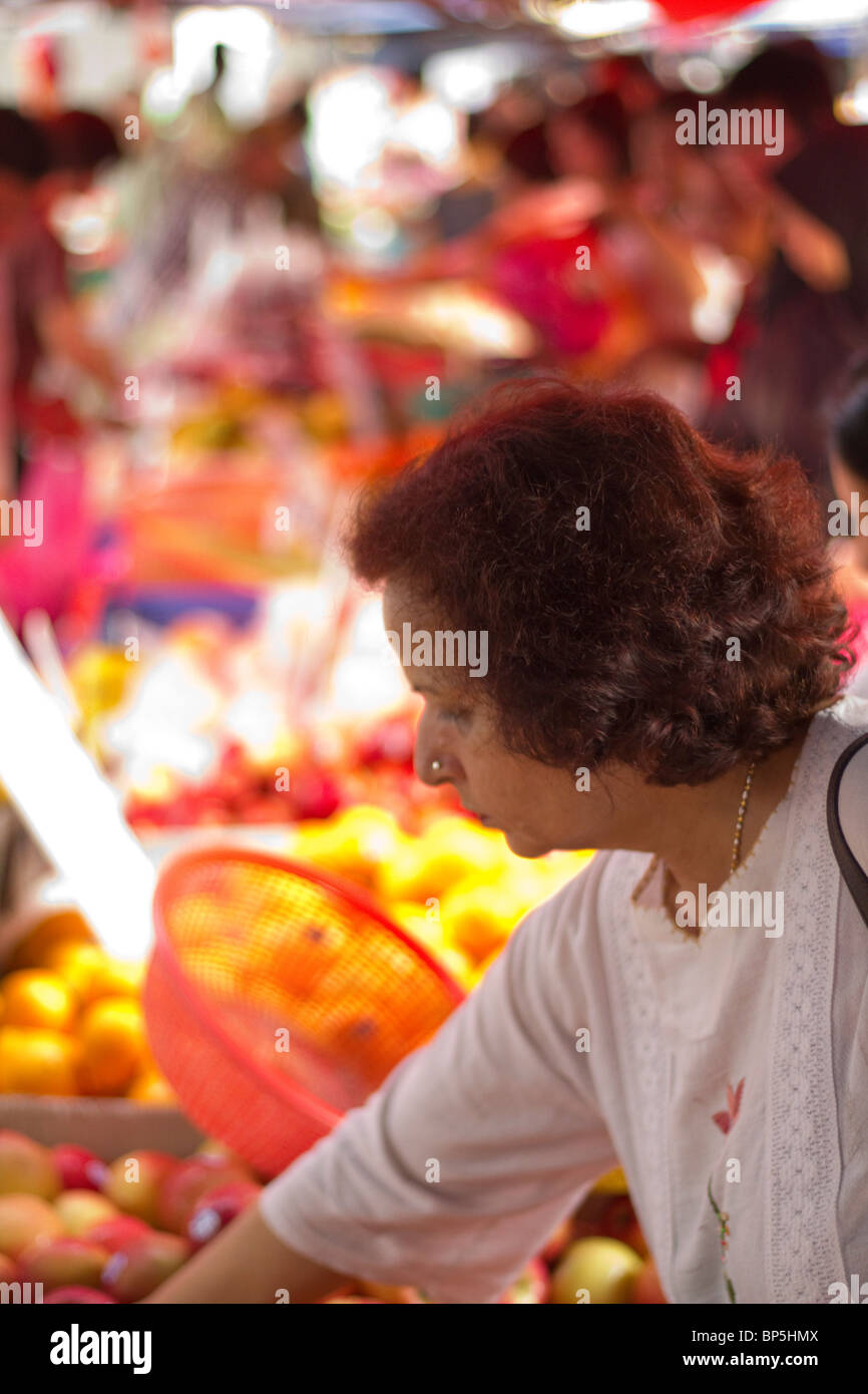 Woman buying fruit at the Sunday night food market, Taman Tun, Kuala Lumpur Stock Photo