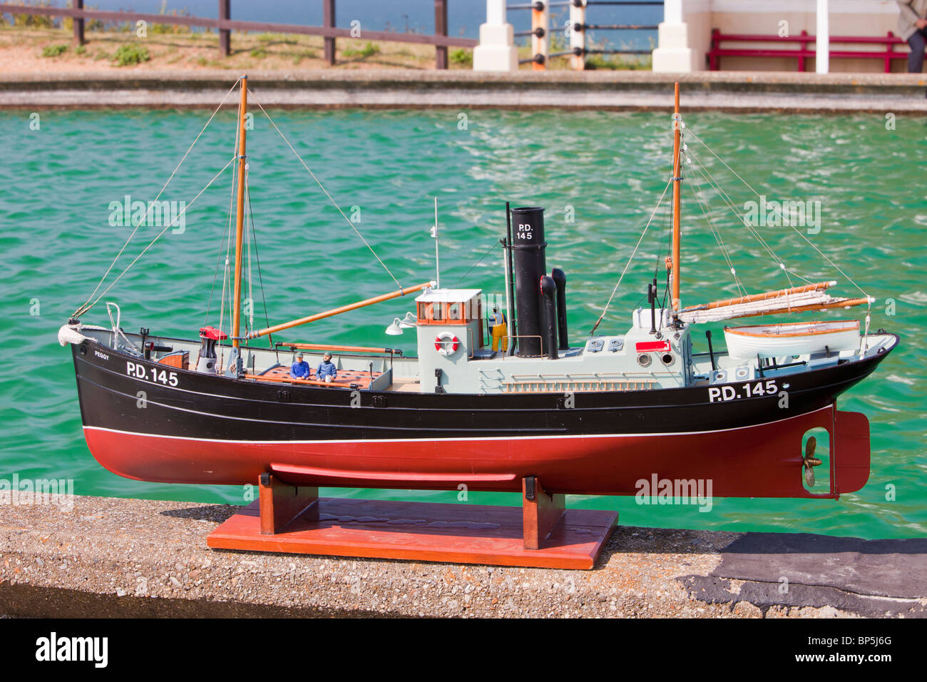 A model fishing boat on the model boating lake at Sheringham, Norfolk, UK. Stock Photo