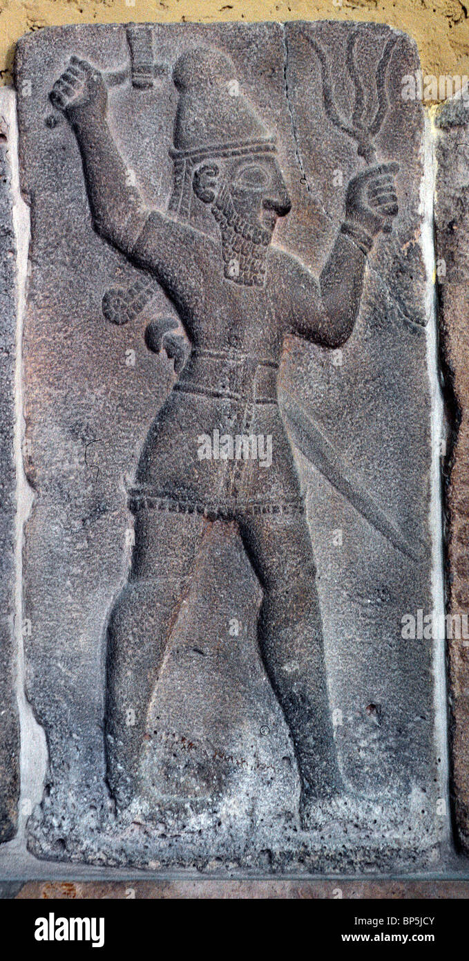 STONE CARVING OF THE HITTITE STORM GOD IN HIS RIGHT HAND HE IS HOLDING LIGHTNING & A BATTLE AX IN HIS LEFT HAND. ZINJIRILI C. Stock Photo