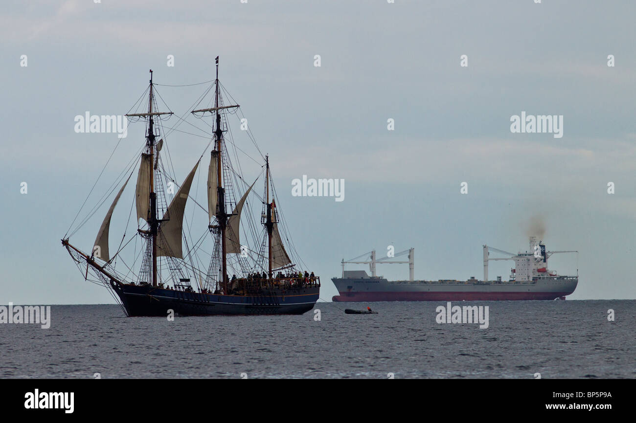 Old and new a large sailing ship sails past a modern day Oil Tanker Dorset Stock Photo Alamy