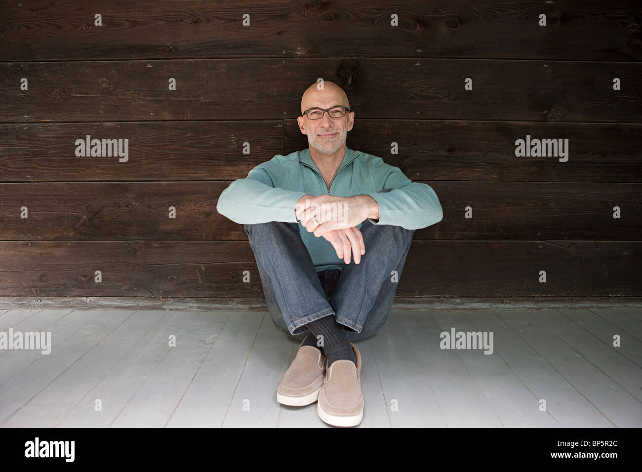 Senior man sitting on floor Stock Photo - Alamy
