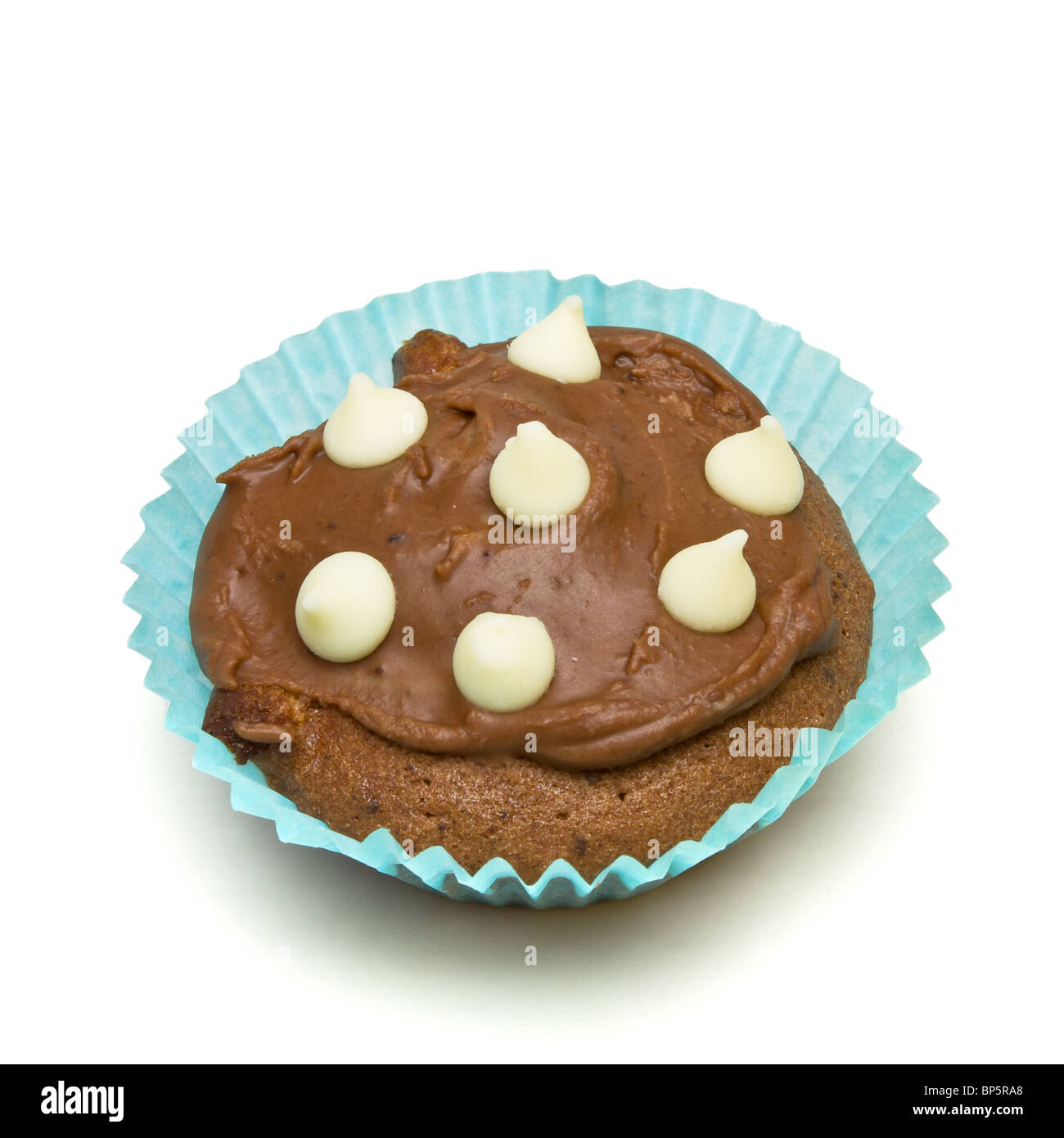Home made milk chocolate cupcake with white chocolate drop decoration. Stock Photo
