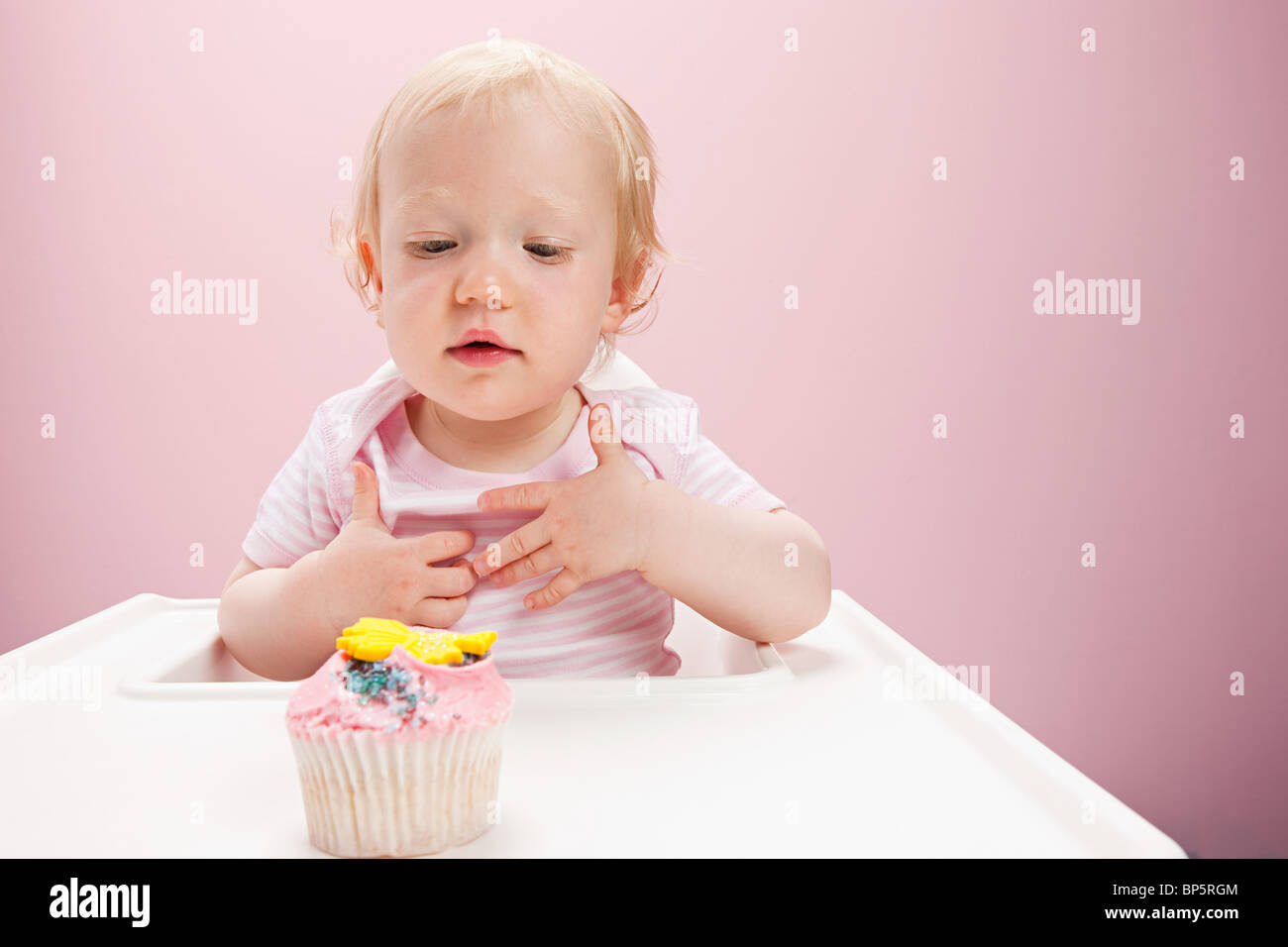 Baby girl with cupcake Stock Photo Alamy