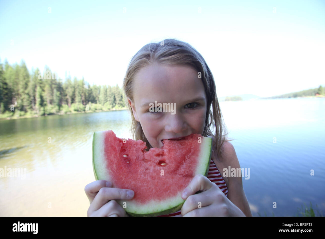 girl eating a slice of watermelon on summer day Stock Photo