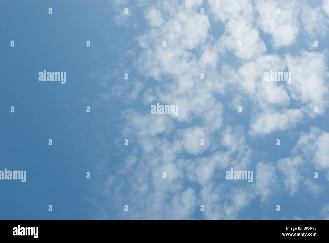 Blue sky and fluffy clouds Stock Photo - Alamy
