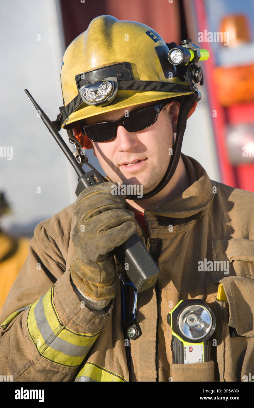 Firefighter holding twoway radio Stock Photo Alamy