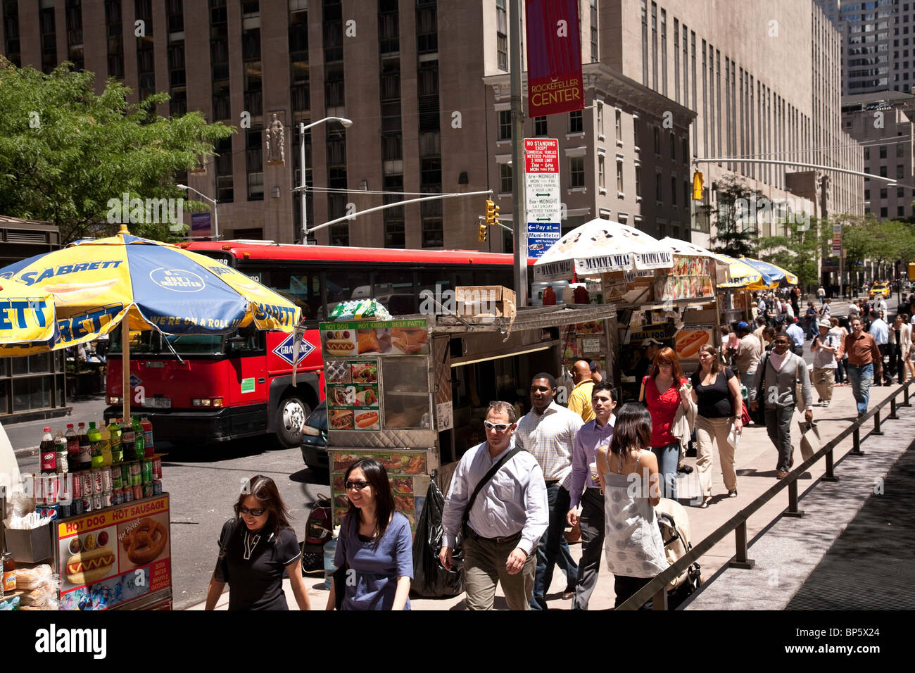 Crowded Sidewalk and Street Food Vendors, Rockefeller Center, NYC Stock Photo