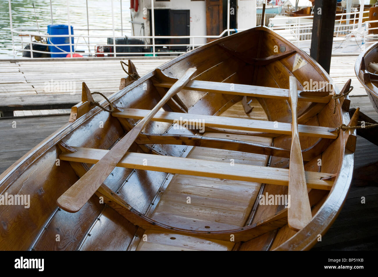 Traditionally built wooden rowing boat with oars at the marine museum in Norheimsund, Western Norway. Stock Photo