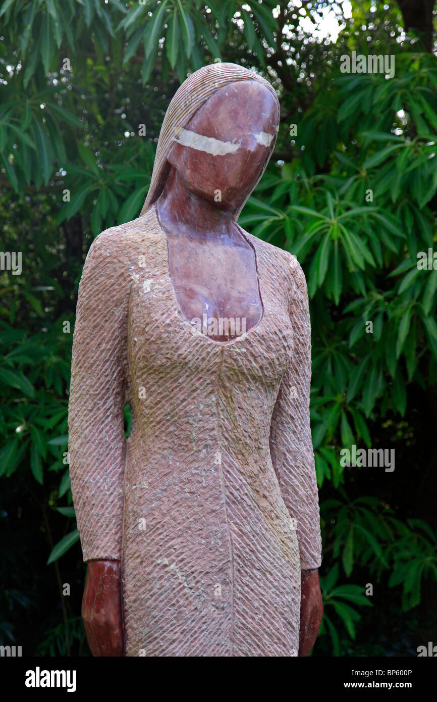 'Woman of Today', (1999) red Jasper sculpture by Gregory Mutasa for sale at Kirstenbosch Botanical Gardens in Cape Town, South Africa. Stock Photo