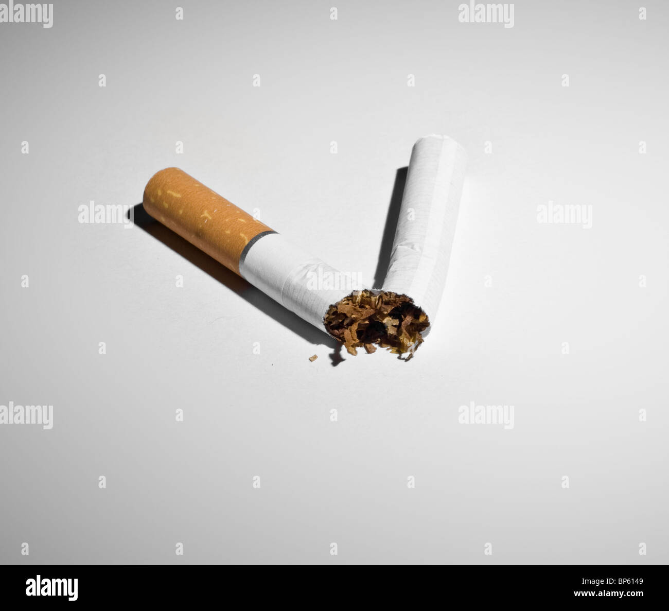 Conceptual photograph for quitting smoking. Broken cigarette Stock