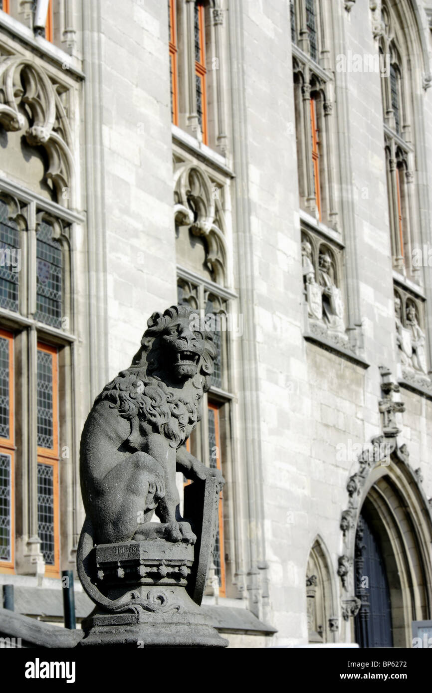 Statue of lion and coat of arms in front of the Provincial Palace House, Market Square, Bruges, Belgium Stock Photo