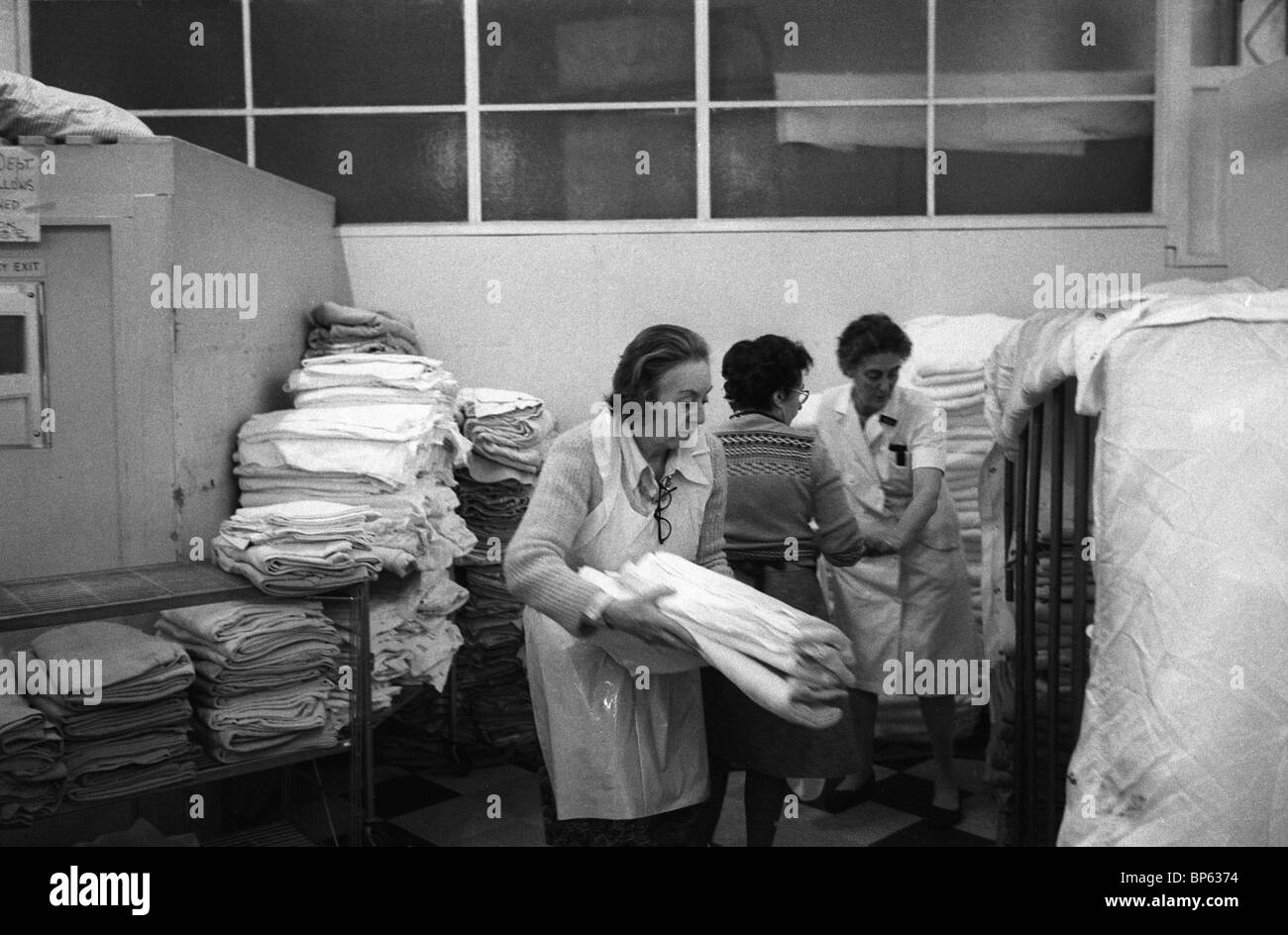 Winter of Discontent London 1979 UK. Family & friends come in to help those staff not striking. Westminster hospital laundry room. 1970s  HOMER SYKES Stock Photo