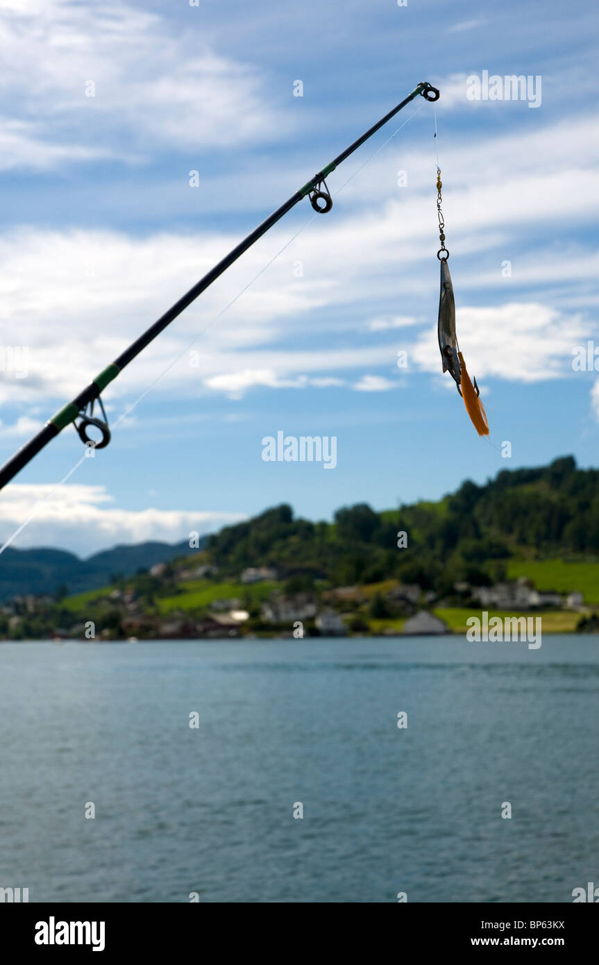 A fishing lure and fishing rod tip ready for action in the Hardanger Fjord, norway Stock Photo