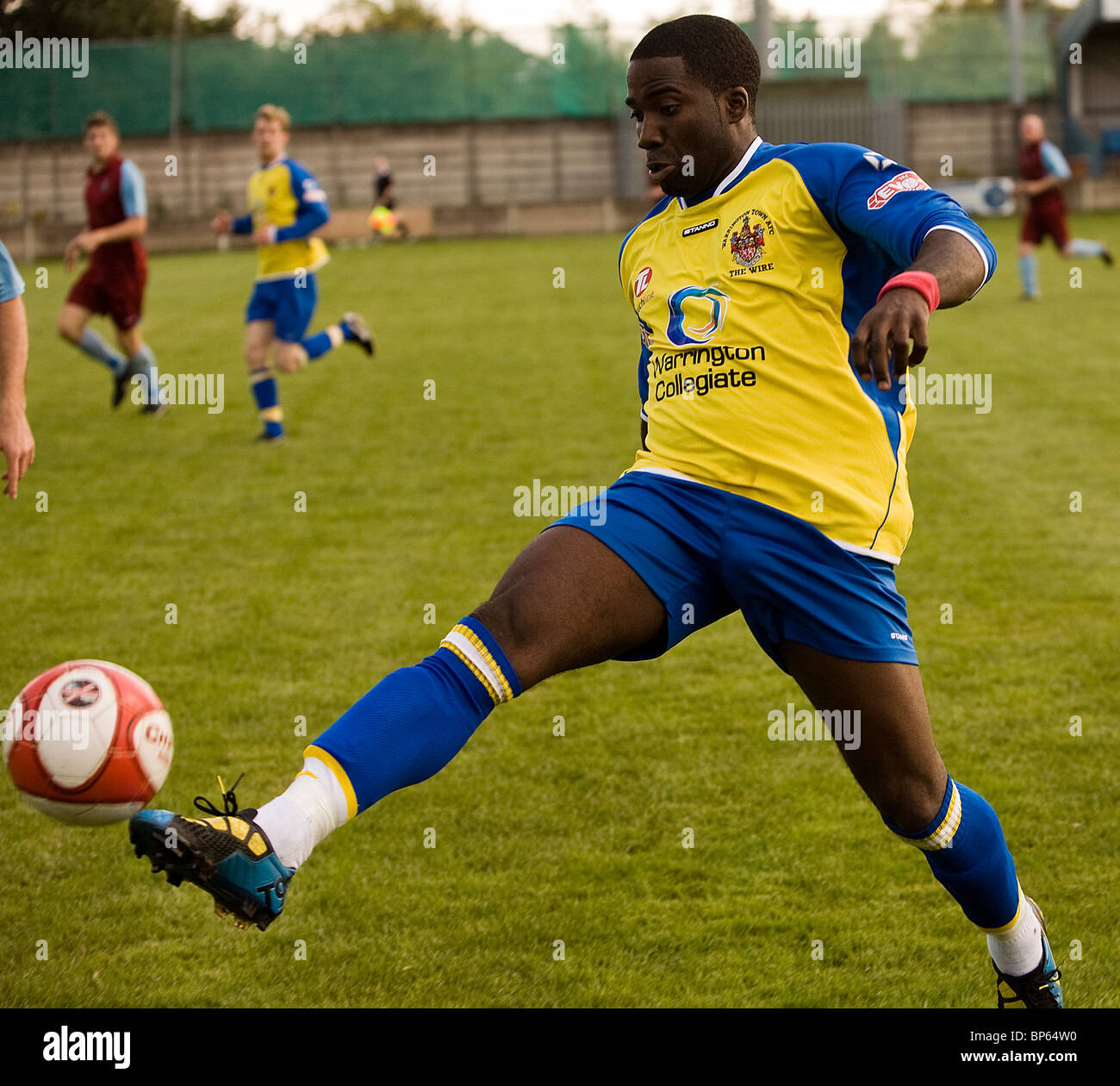 A striker from Warrington Town controls the ball in a pre-season friendly against Colwyn Bay at Cantilever Park Stock Photo